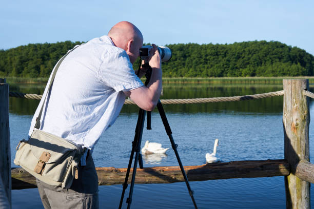 istock Photographer on a lake 821924276