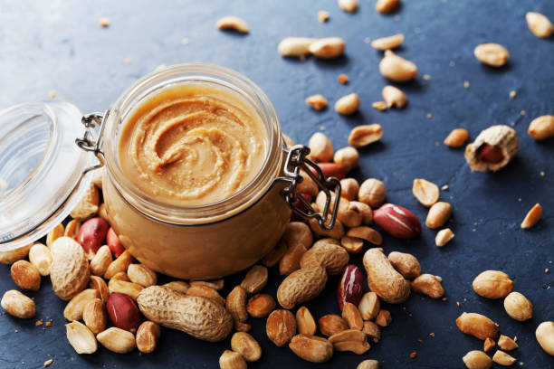 istock Peanut or groundnut butter with nuts. Vintage style. 821927564