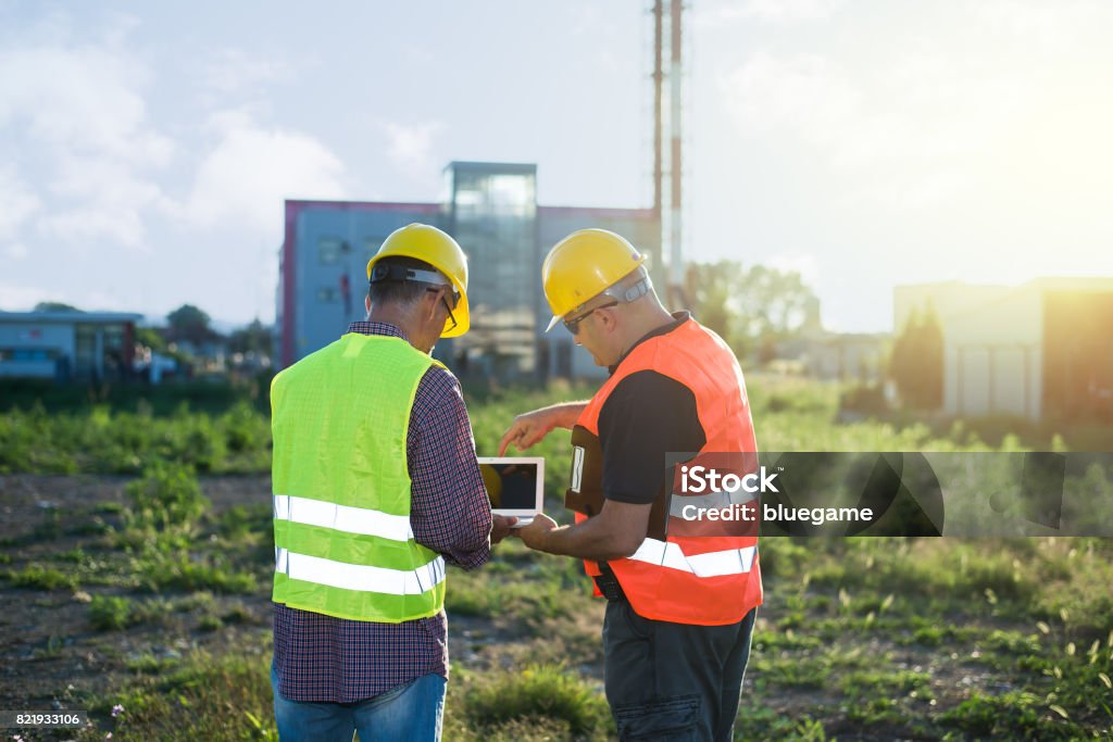 Engineers at industrial facility Construction Industry Stock Photo