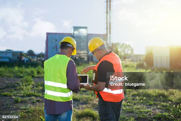 Engineers At Industrial Facility Stock Photo - Download Image Now - Construction Industry, Construction Site, Discussion
