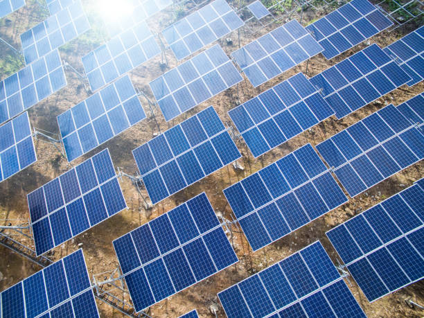 istock Solar panels (solar cell) in solar farm with  lighting. 821933262
