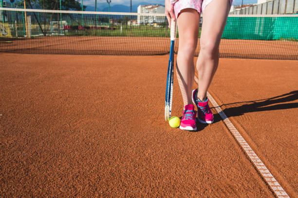 istock Female legs with tennis racket 821933618