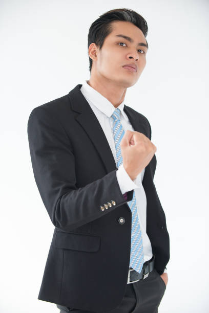 istock Aggressive young businessman threatening with fist 821937242