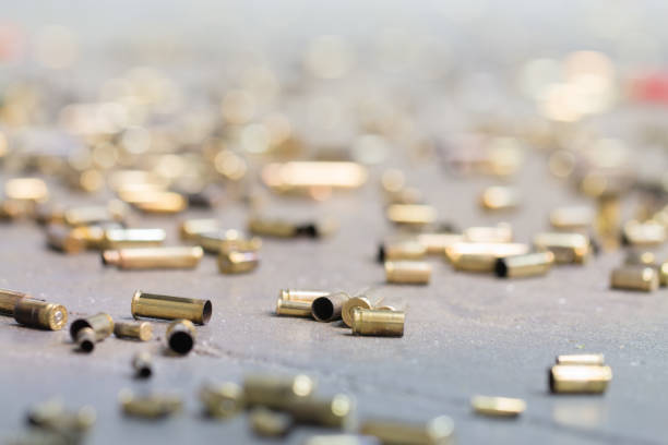 Spent shell casings. Spent shell casings on cement background. bullet cartridge photos stock pictures, royalty-free photos & images