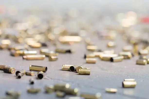 Spent shell casings on cement background.