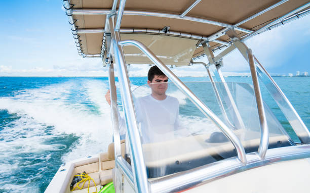Teenager driving a boat