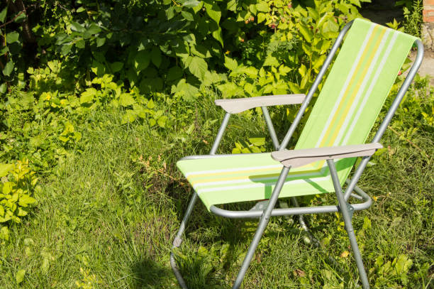istock Folding chair for camping on green grass 821946706