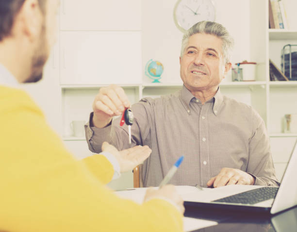 istock Mature man sign car purchase contract 821947660