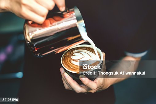istock How to make latte art by barista focus in milk and coffee in vintage color tone. 821951196