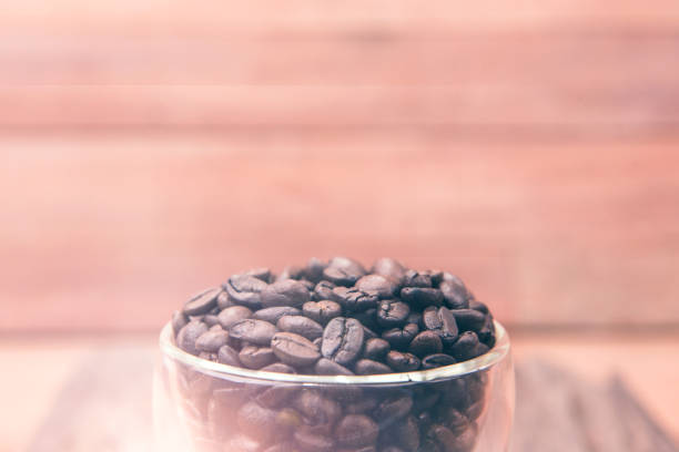 Coffee. Coffee beans. Coffee cup full of coffee beans. Toned image. stock photo