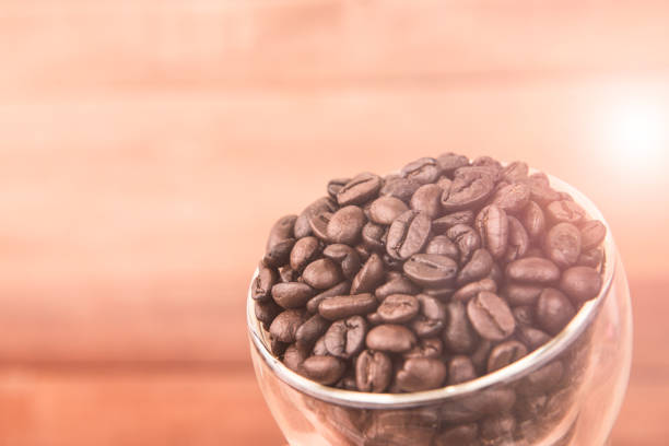 Coffee. Coffee beans. Coffee cup full of coffee beans. Toned image. stock photo