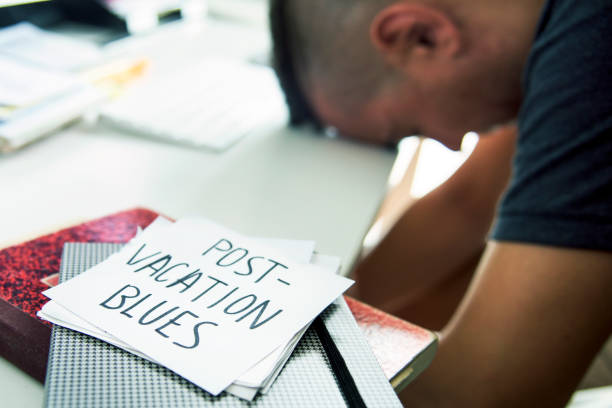 istock man at office and text post-vacation blues 821951752