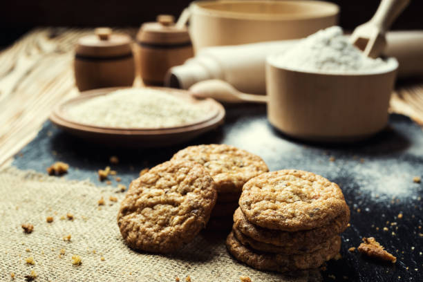 istock Biscuit sweet cookie background. Domestic stacked butter biscuit pattern concept,close up macro.Homemade cookies on wooden table.Cereal biscuits with the sesame,peanuts,sunflower and amaranth. 821953062