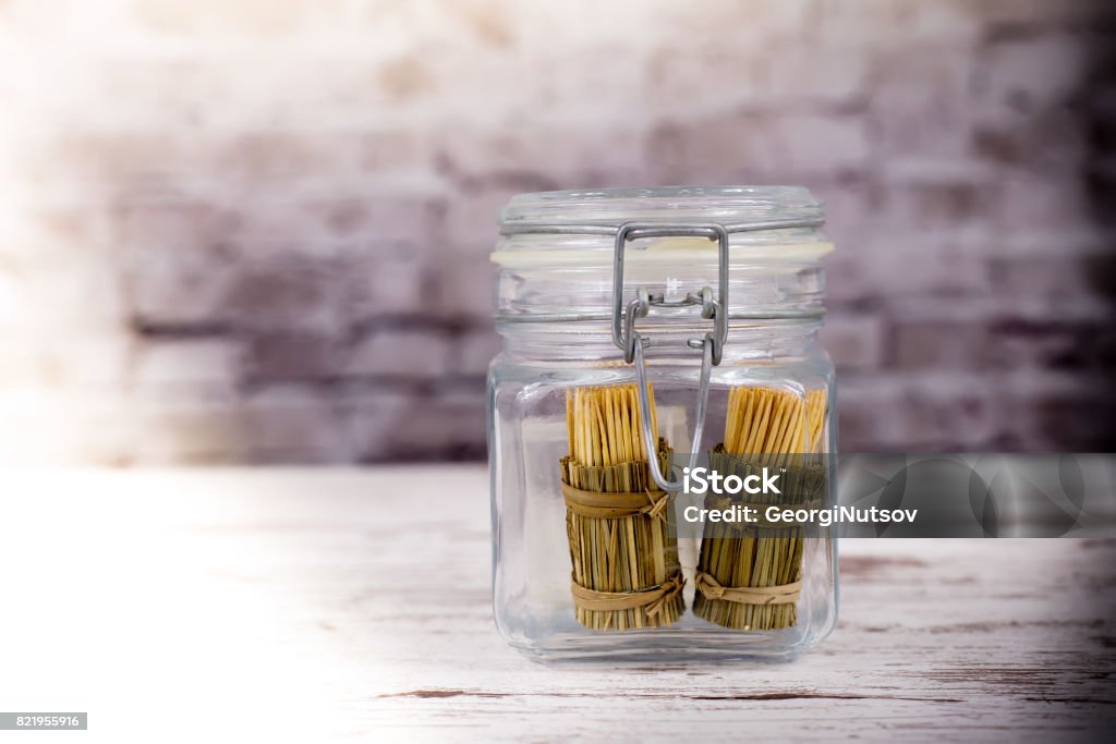 Exotic wrapped toothpicks in a glass jar of spices. Archival Stock Photo