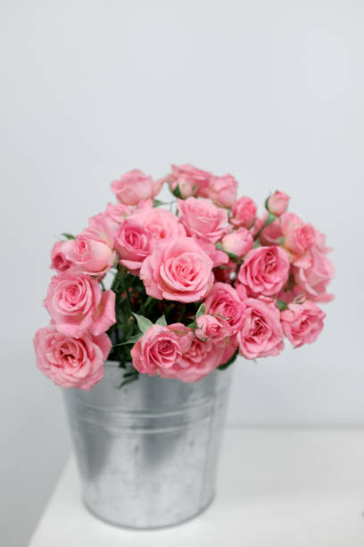 istock Pink bush roses in a bucket 821956566