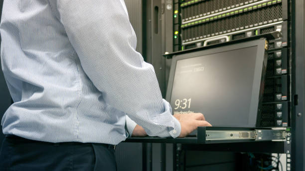 istock Close up part of administrator working in data center 821957414