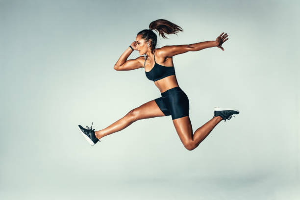 istock Fit young woman jumping in air 821961906