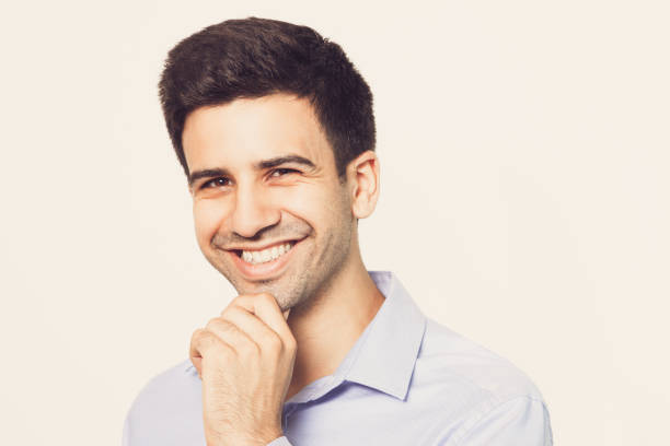 istock Smiling Young Attractive Man Touching Chin 821962400