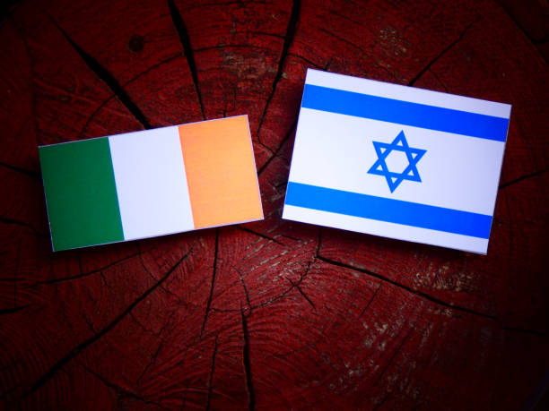istock Irish flag with Israeli flag on a tree stump isolated 821976816