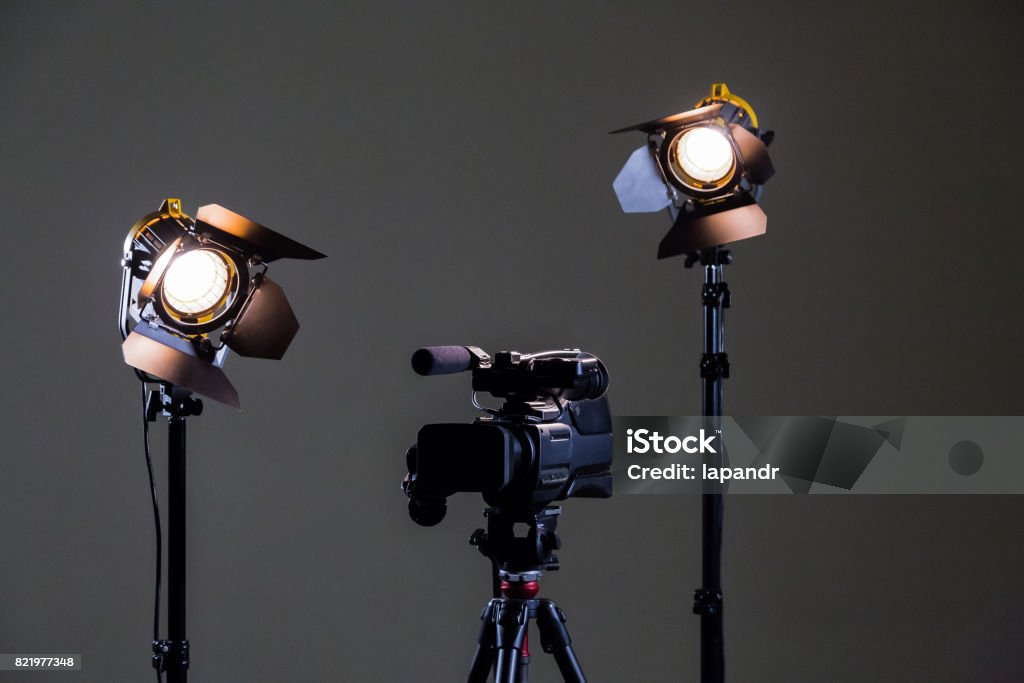 Camcorder and 2 spotlights with Fresnel lenses in the interior. Shooting an interview Camcorder and 2 spotlights with Fresnel lenses in the interior. Shooting an interview. Filming Stock Photo