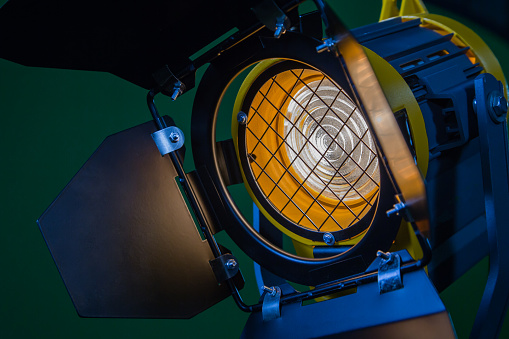 A spotlight with a Fresnel lens and a halogen lamp. Equipment for photographing and filming in the interior. Close-up