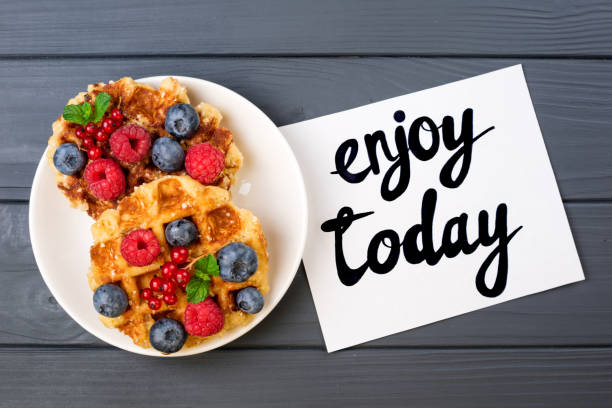 istock Traditional belgian waffles with berries and note Enjoy today. Flat lay, top view 822013210
