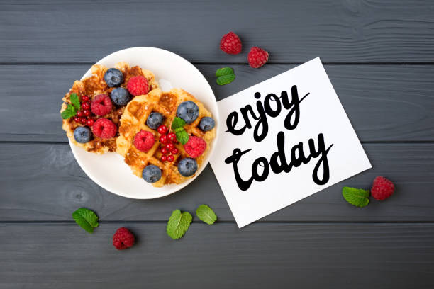istock Traditional belgian waffles with berries and note Enjoy today. Breakfast concept. Flat lay, top view 822013274