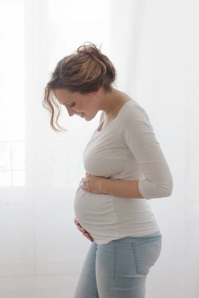 istock Pregnant woman touching belly 822013284
