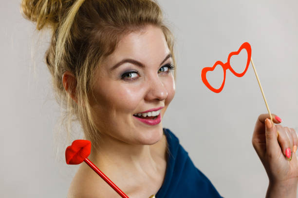 istock woman holds carnival accessories on stick 822014288