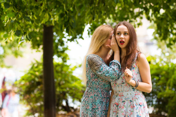 istock Two pretty cuter teenagers shares secrets 822015140