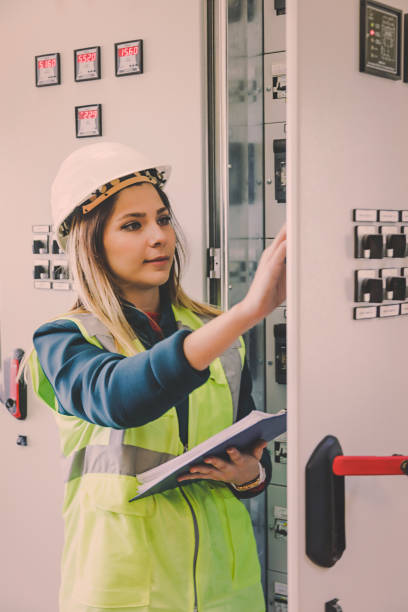 istock Young female maintenance engineer working at energy control room 822034284