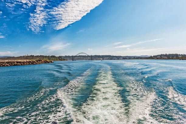 istock Leaving Newport Oregon by boat Yaquina Bridge under Clouds 822034510