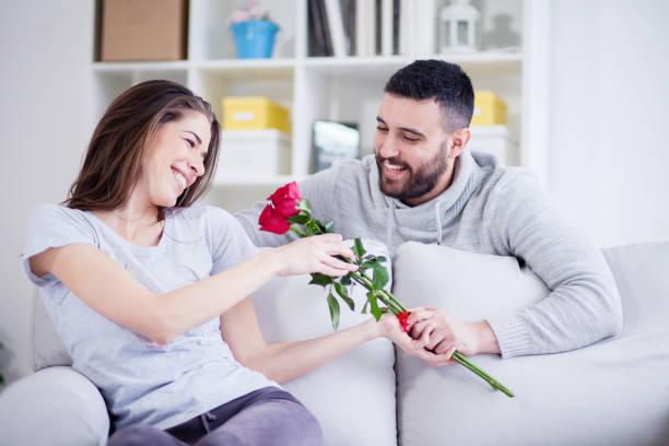 istock Man giving a red rose to his girlfriend 822060662