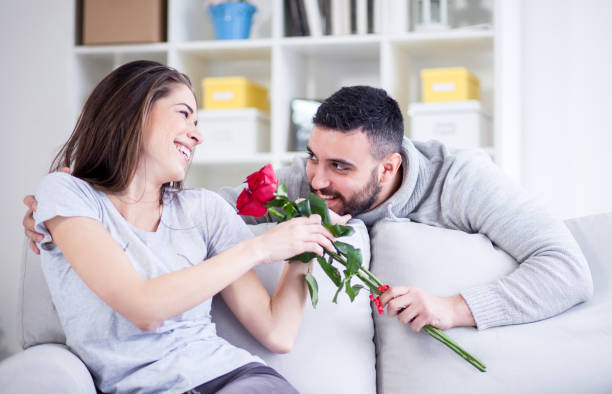 istock Man giving a red rose to his girlfriend 822060694