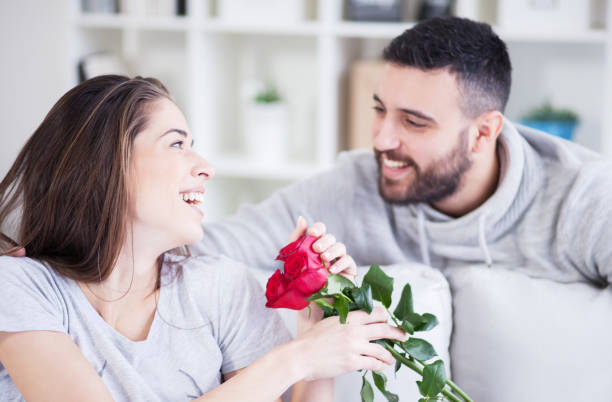 istock Man giving a red rose to his girlfriend 822061412