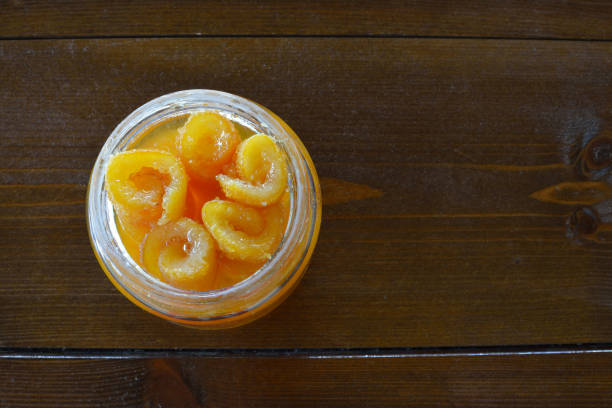 istock Vase of preserved oranges on a wooden table 822066826