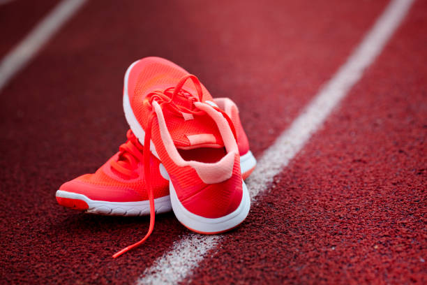 istock Close up on pink shoes on the running track 822067130
