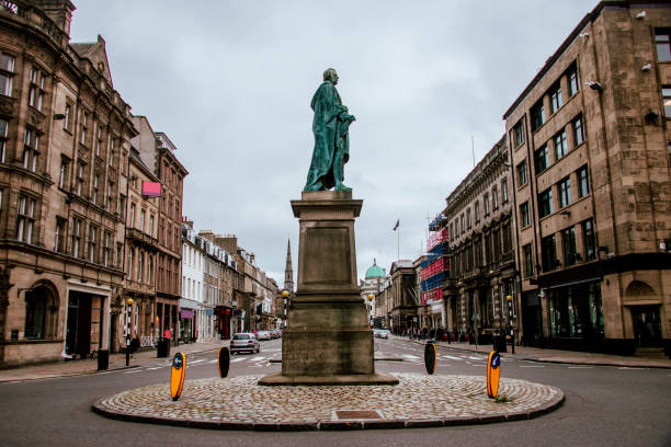 Edinburgh, Scotland, UK - February 4, 2014: A statue of the 18th Century economist and philosopher Adam Smith, an important figure in the Scottish Enlightenment.  The statue is located on Edinburgh's High Street, part of the Royal Mile which runs between Edinburgh Castle and Holyrood Palace.