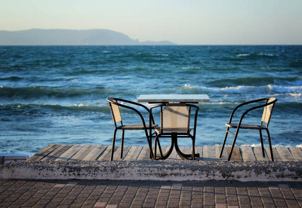 istock Table and chairs on the beach in the early summer morning 822085206
