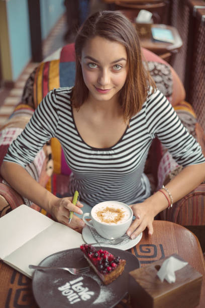 Young woman sitting indoor in urban cafe