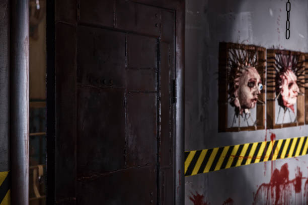 istock Frightful iron door near ghastly faces stuck in square frames 822105548