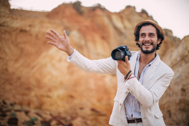 istock Smiling Photographer making pictures at the beach 822106376