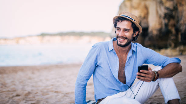 istock Listening music at beach 822111132