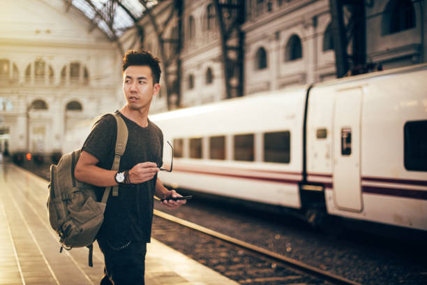 istock Chinese hipster man on a train station 822116254