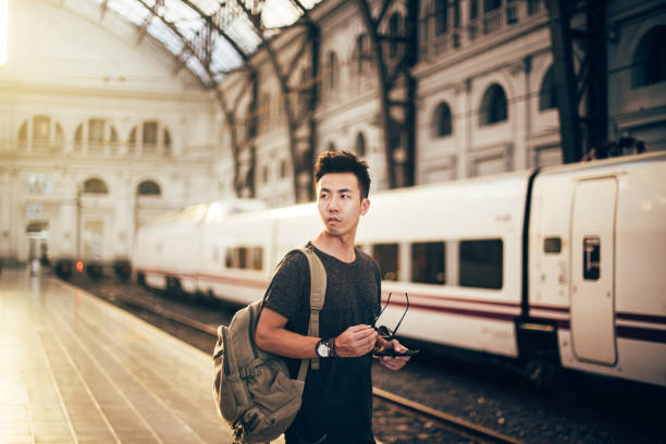 istock Chinese hipster man standing on station 822116376