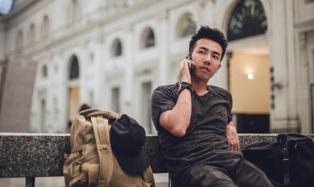 istock Passenger sitting on bench at train station 822119470