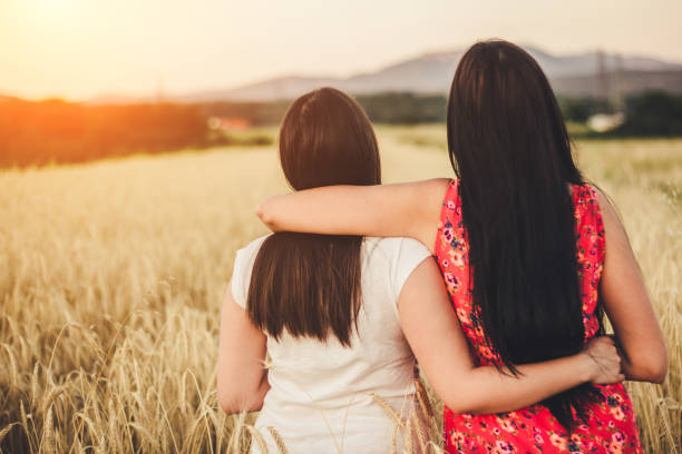 istock Two young women in wheat field have fun. 822124728