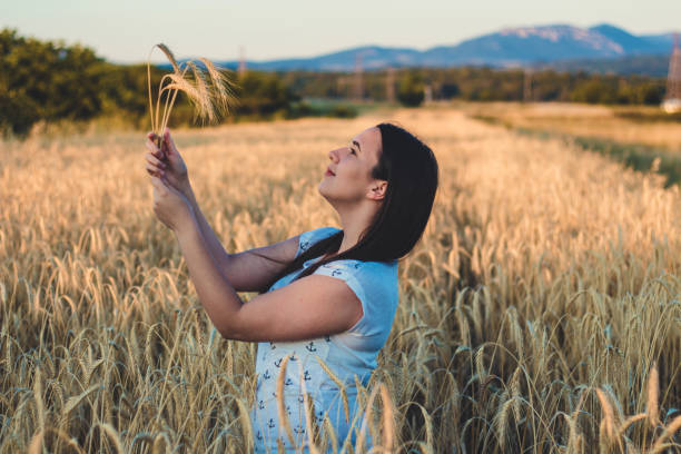 istock Beautiful young girl in a wheat field. 822133476