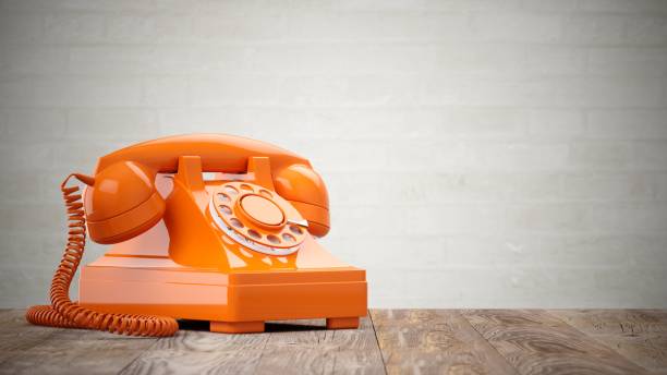 istock 3D rendering orange vintage phone on wood table 822141810