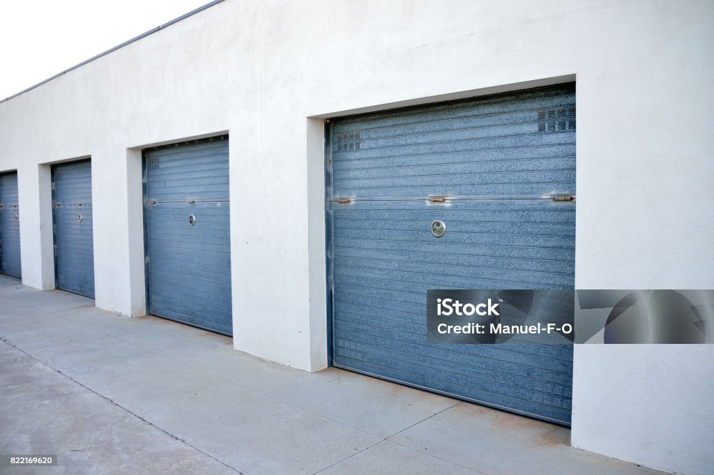 Storage units in a self storage facility at outdoor group of many storage warehouse building with a group closed doors. Storage room Self Storage Stock Photo